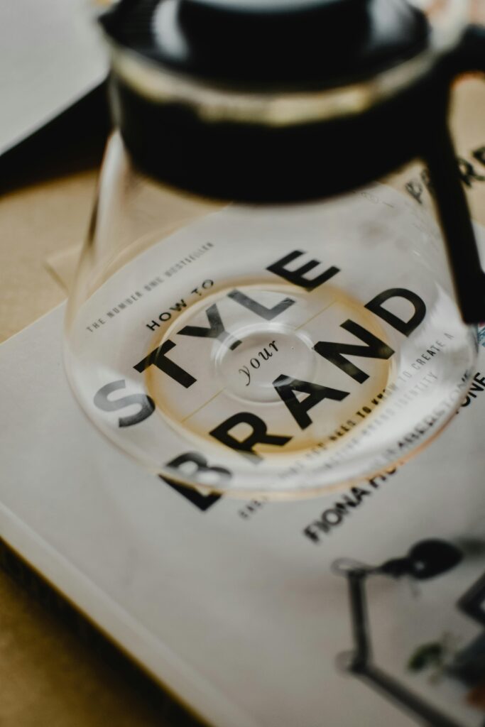 A coffee pot rests atop a book titled 